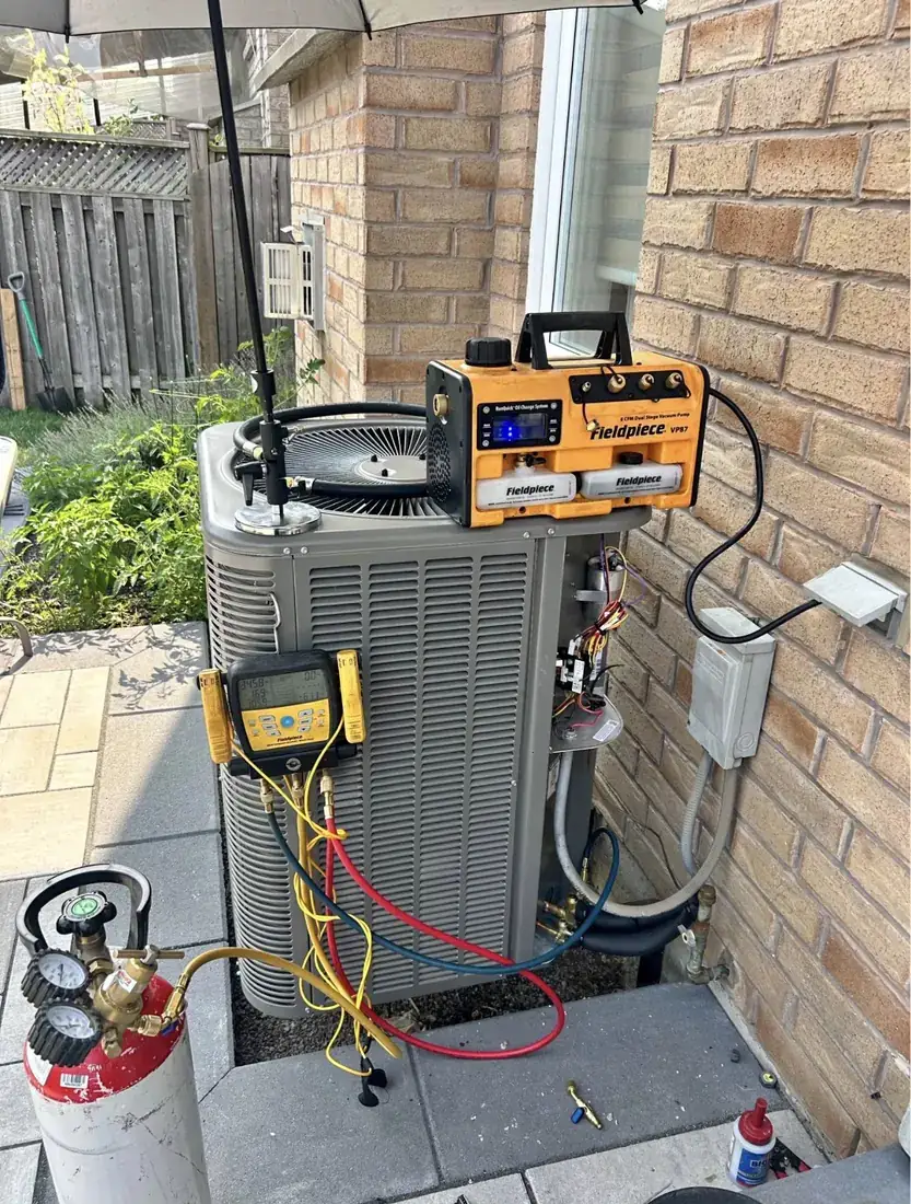Evacuating and charging an air conditioner with a vacuum pump, manifold gauges and nitrogen