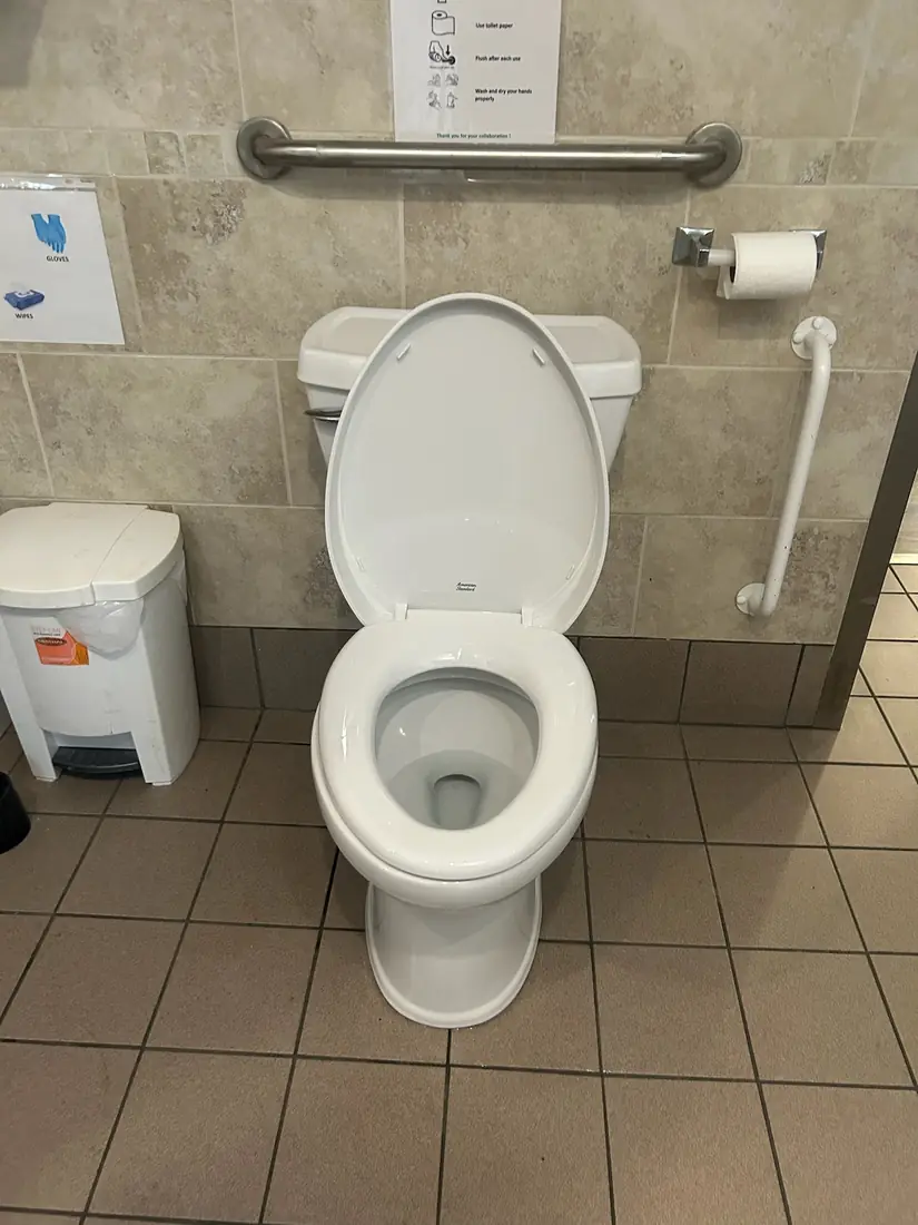 American Standard commercial toilet installed with grab bars