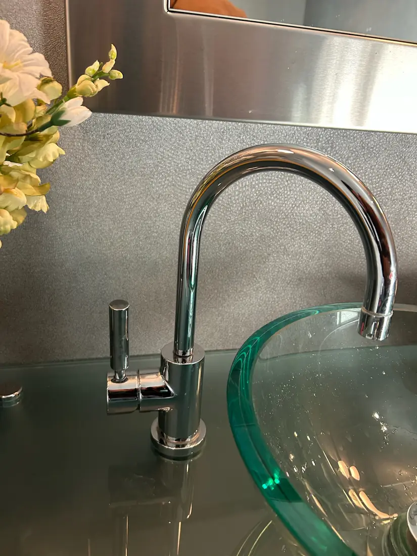 Chrome faucet paired with a glass vessel basin