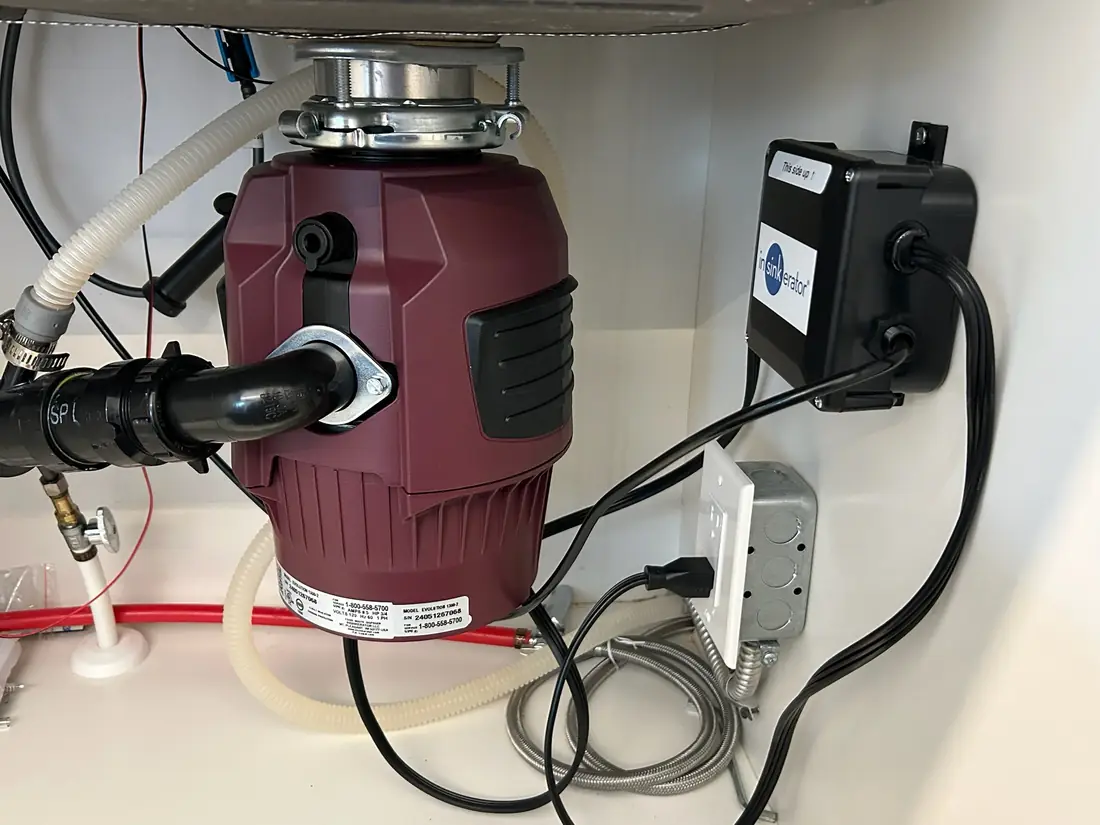 InSinkErator Evolution garburator wired and plumbed under a kitchen sink