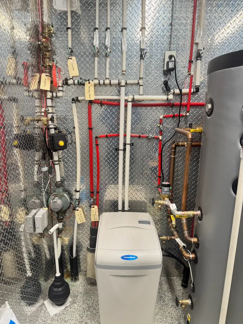 Tagged and labelled mechanical room with WaterBoss softener and hot water tank