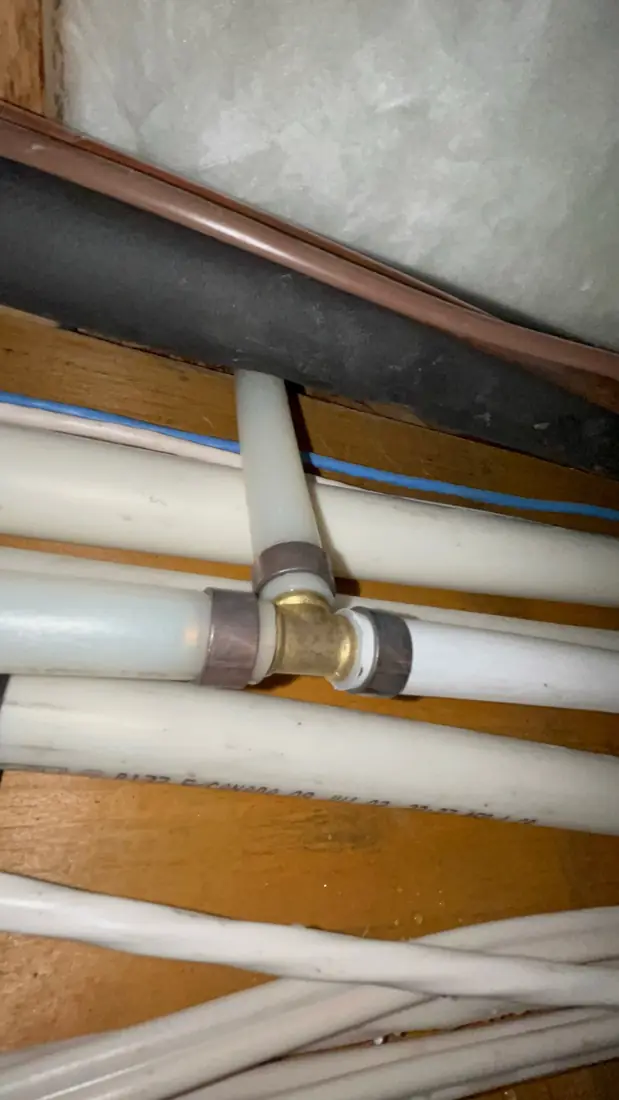 PEX tee fitting repaired in a floor joist bay
