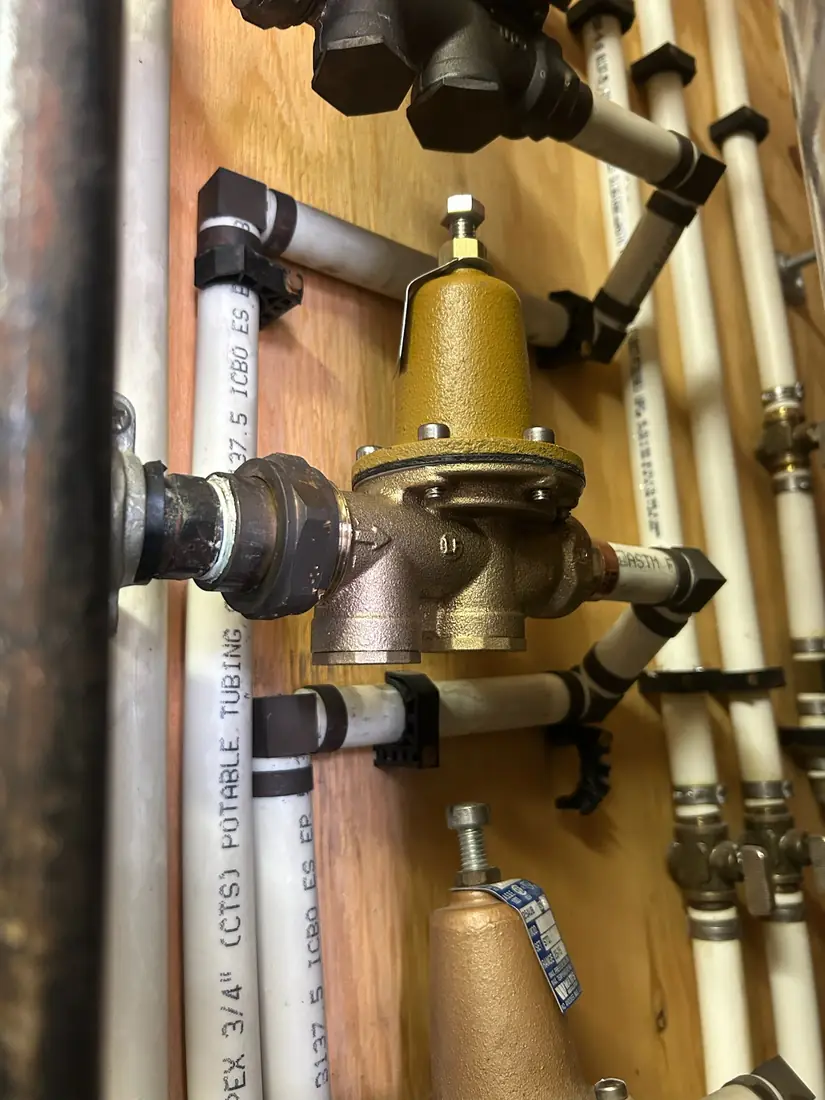Watts pressure reducing valve on a PEX manifold board